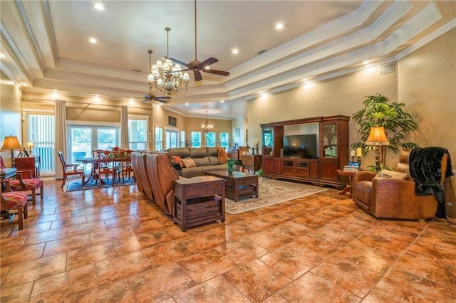 living room with ceiling fan with notable chandelier, a high ceiling, a tray ceiling, and crown molding