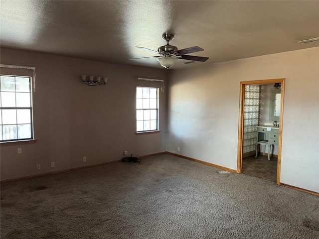 spare room with a textured ceiling, ceiling fan, and carpet flooring