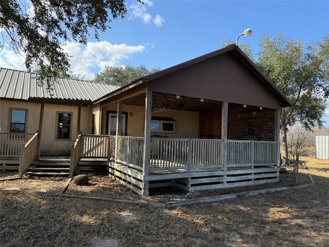 back of house featuring covered porch