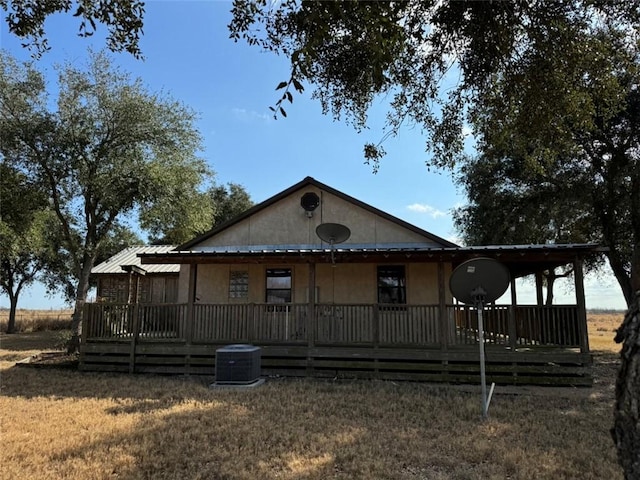 exterior space featuring a yard and central AC