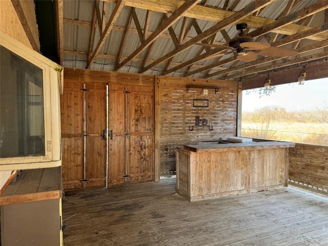 bar with vaulted ceiling, dark hardwood / wood-style floors, and ceiling fan