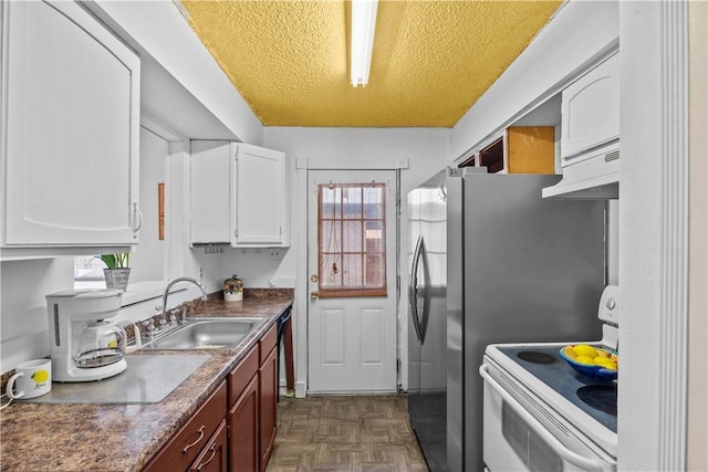 kitchen with a healthy amount of sunlight, white cabinetry, a sink, and electric range