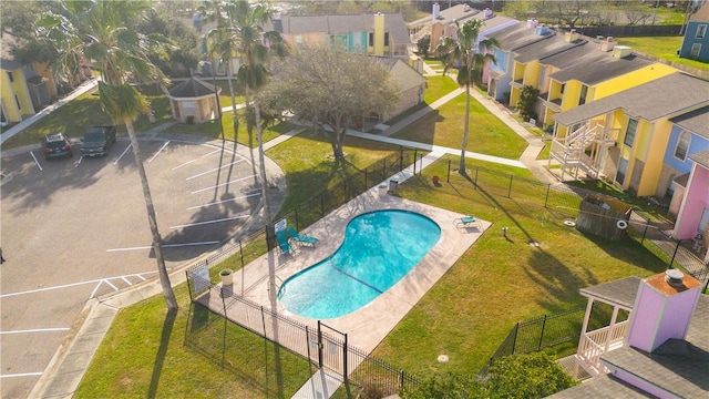 pool with a residential view, fence, and a patio