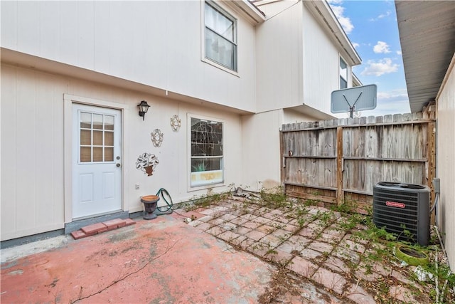 exterior space featuring a patio area, fence, and central AC