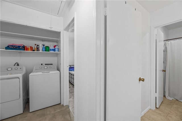 clothes washing area with attic access and independent washer and dryer