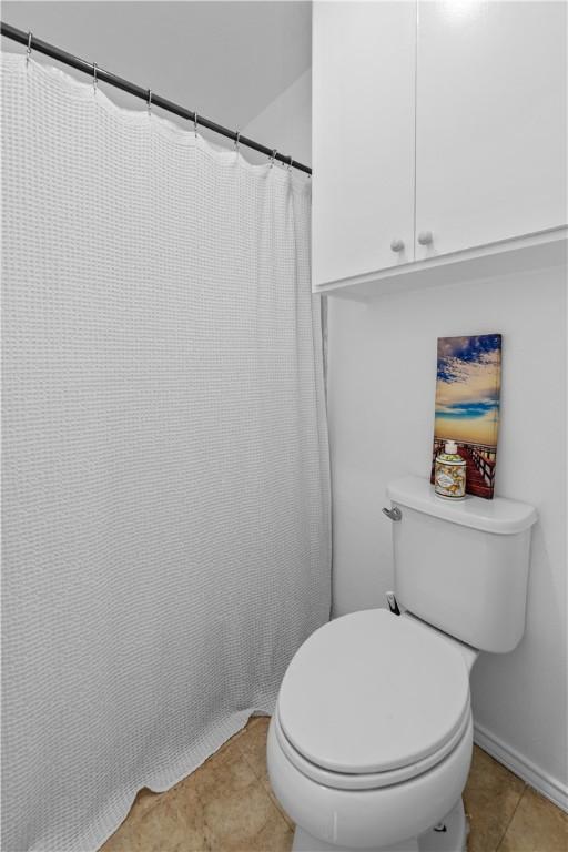 full bathroom with tile patterned flooring and toilet