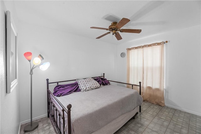 bedroom with ceiling fan and baseboards