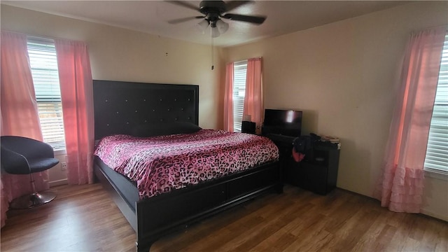 bedroom with ceiling fan and wood finished floors