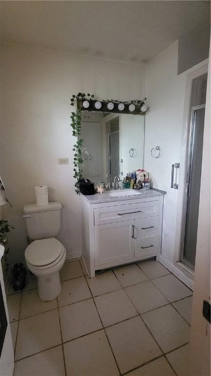 bathroom featuring toilet, tile patterned flooring, vanity, and a shower stall