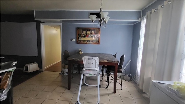 dining area featuring light tile patterned floors, a healthy amount of sunlight, visible vents, and an inviting chandelier