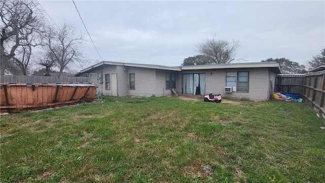 back of property featuring a lawn, cooling unit, a fenced backyard, and a fenced in pool