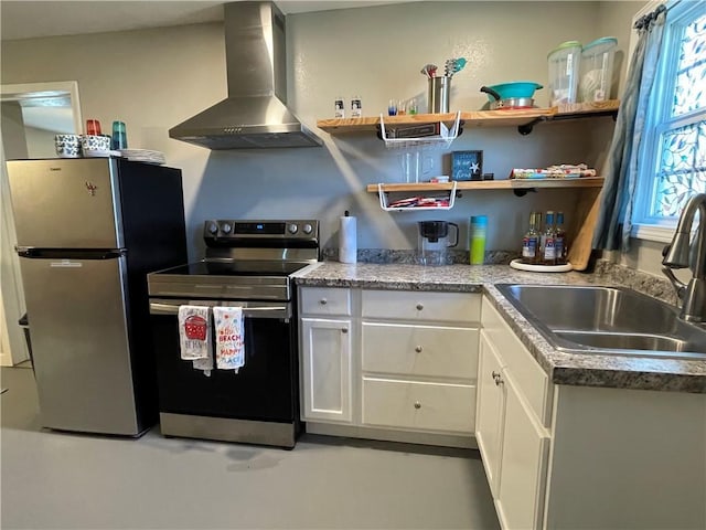 kitchen with appliances with stainless steel finishes, sink, white cabinets, and wall chimney exhaust hood