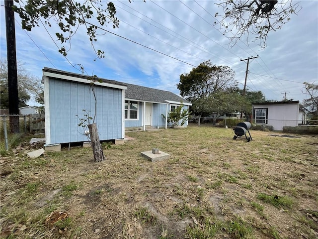 back of house with a lawn