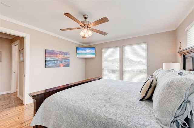 3 Mazatlan Dr, Rockport, TX 78382 - bedroom with light wood-style floors, crown molding, baseboards, and ceiling fan