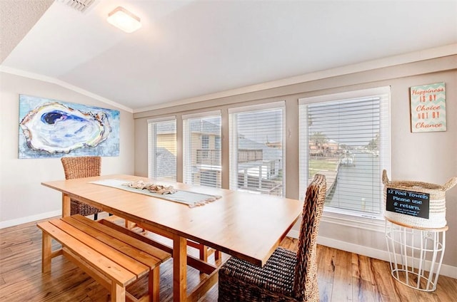 3 Mazatlan Dr, Rockport, TX 78382 - dining space with baseboards, vaulted ceiling, light wood finished floors, and crown molding