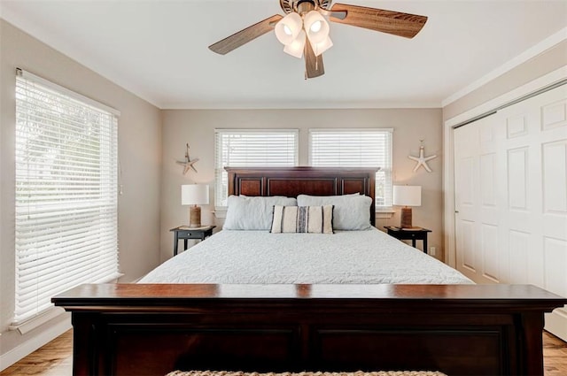 3 Mazatlan Dr, Rockport, TX 78382 - bedroom featuring light wood finished floors, crown molding, a closet, a ceiling fan, and baseboards