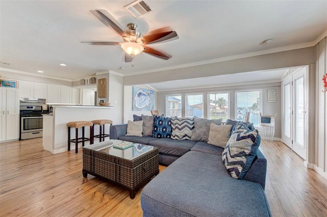 3 Mazatlan Dr, Rockport, TX 78382 - living room featuring ornamental molding, light wood-style flooring, a ceiling fan, and recessed lighting