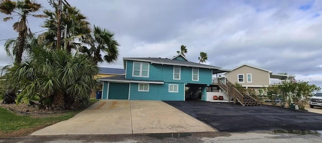 3 Mazatlan Dr, Rockport, TX 78382 - rear view of property featuring driveway, stairs, and a carport