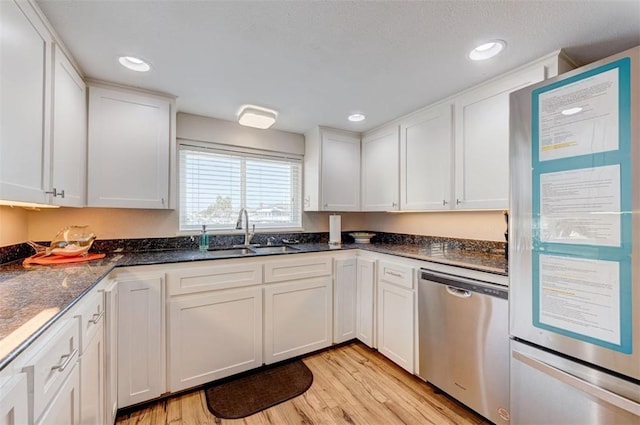 3 Mazatlan Dr, Rockport, TX 78382 - kitchen featuring dishwasher, a sink, light wood-style flooring, white cabinetry, and recessed lighting