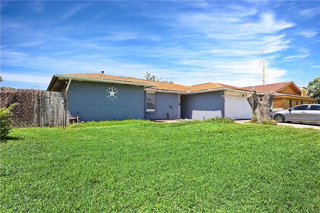 single story home featuring a garage and a front yard