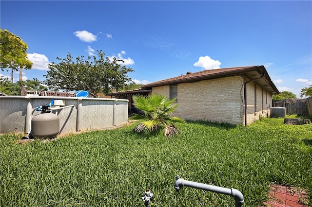 view of home's exterior with central AC and a lawn