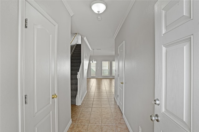 hallway featuring light tile patterned flooring and ornamental molding