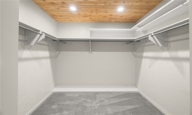 walk in closet with carpet floors