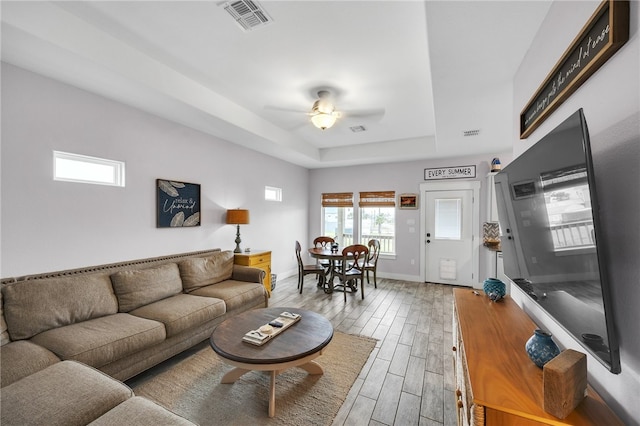 70 Belaire Dr, Rockport, TX 78382 - living area featuring ceiling fan, a raised ceiling, baseboards, wood finished floors, and visible vents