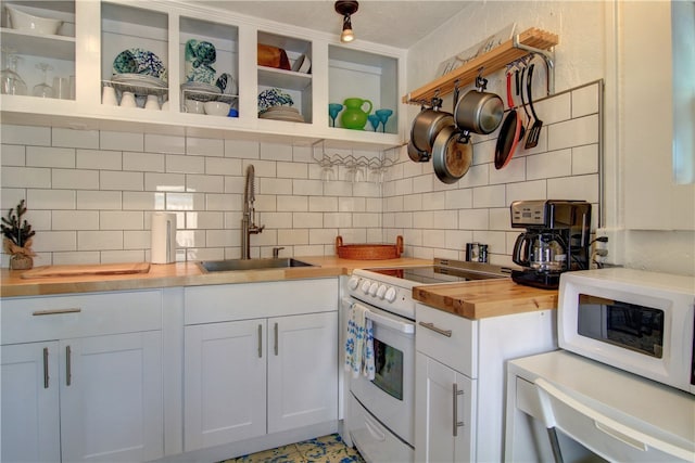 kitchen with white cabinetry, sink, white appliances, wood counters, and decorative backsplash