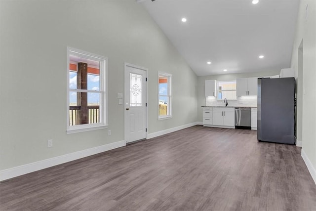 kitchen with baseboards, appliances with stainless steel finishes, dark wood-type flooring, and white cabinets