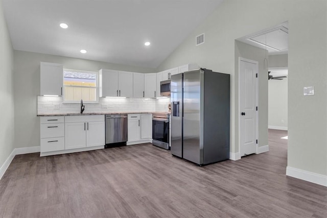 kitchen featuring white cabinets, visible vents, stainless steel appliances, and a sink