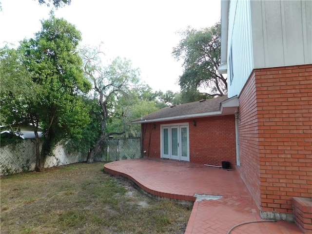 view of yard with a patio area and french doors