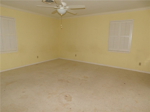 unfurnished room with ceiling fan, crown molding, and carpet floors