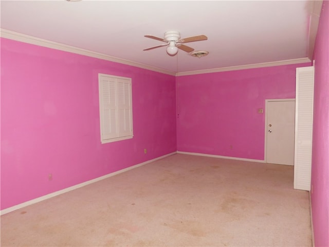 spare room with ceiling fan, light colored carpet, and ornamental molding