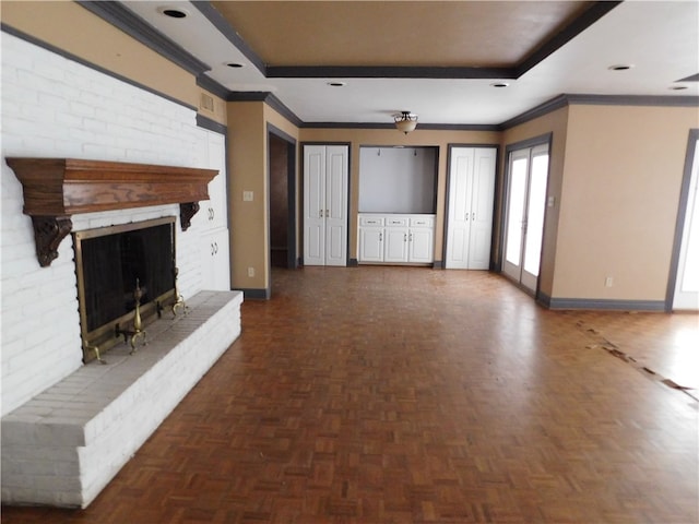 unfurnished living room with a brick fireplace, dark parquet floors, and ornamental molding