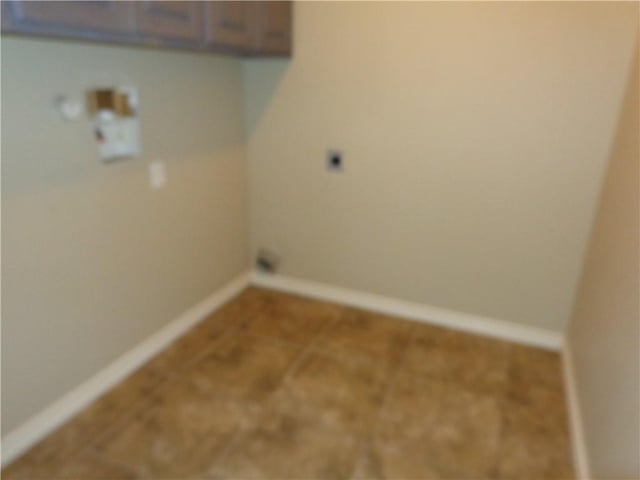 washroom featuring electric dryer hookup and cabinets