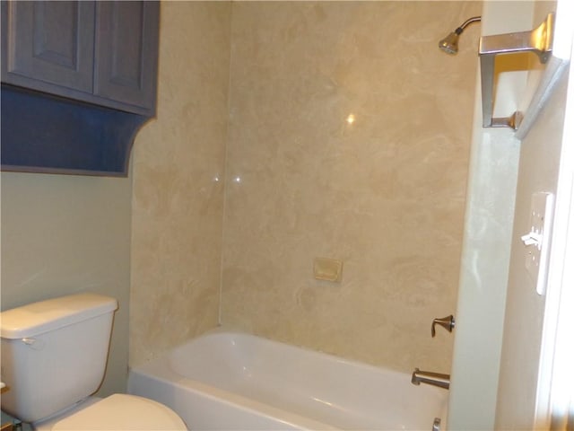 bathroom featuring tiled shower / bath and toilet