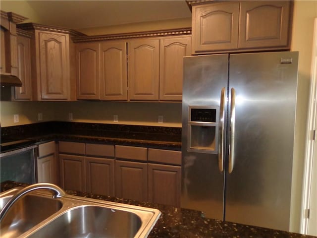 kitchen featuring stainless steel refrigerator with ice dispenser and sink