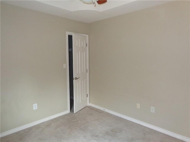 carpeted spare room with ceiling fan