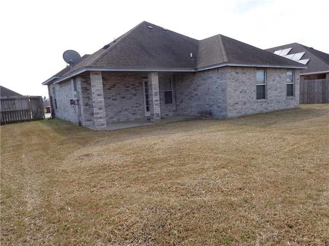 back of house with a lawn