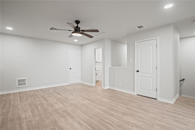 unfurnished room with visible vents, ceiling fan, and light wood-style flooring