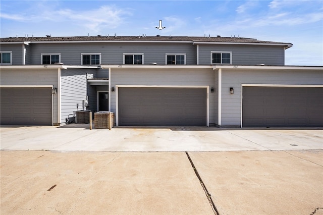 multi unit property featuring driveway and an attached garage