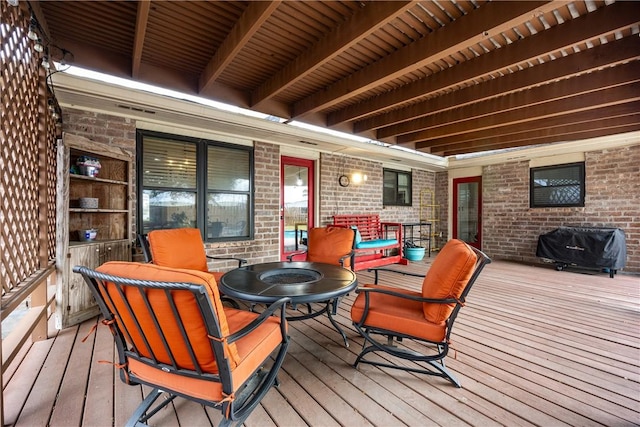 wooden terrace featuring grilling area