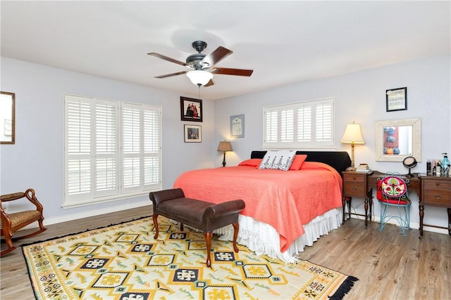 bedroom with ceiling fan and light hardwood / wood-style floors