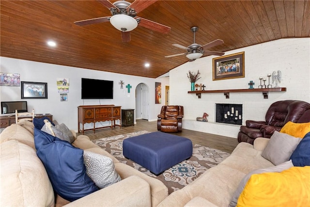 living room with dark hardwood / wood-style flooring, a brick fireplace, wood ceiling, and vaulted ceiling