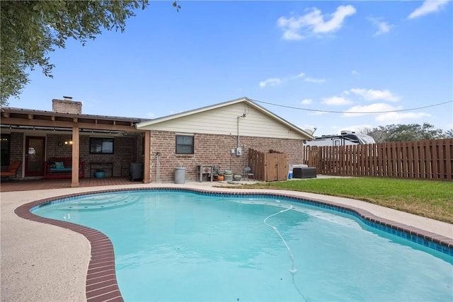 view of pool with cooling unit and a lawn