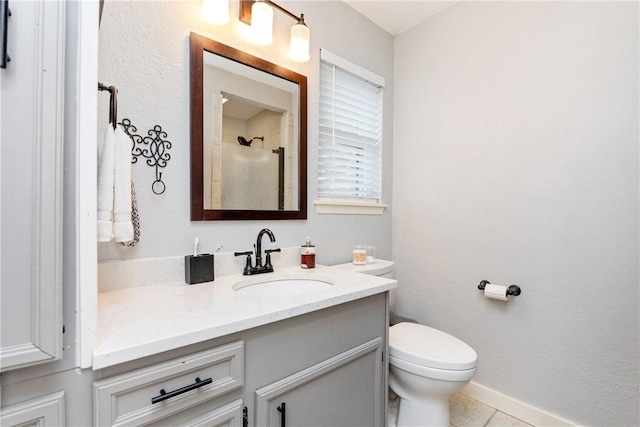 bathroom featuring tile patterned floors, vanity, and toilet