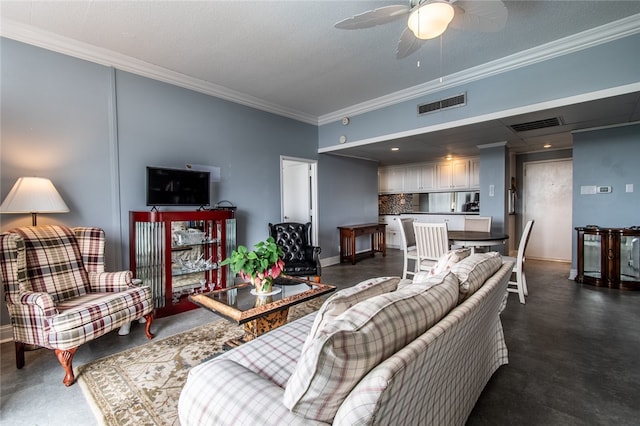 living room featuring ceiling fan, a textured ceiling, and ornamental molding