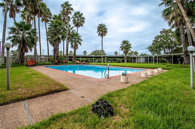 view of pool featuring a yard