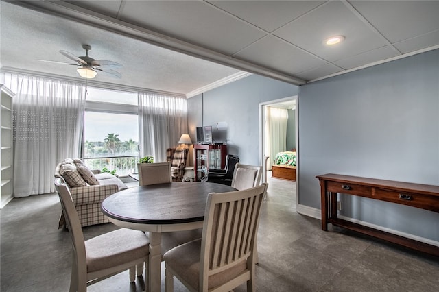 dining room with ceiling fan and crown molding